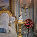Load image into Gallery viewer, Decorative figurine on a gold pedestal in an ornate room setting
