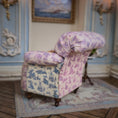 Load image into Gallery viewer, Floral-patterned armchair in a decorative room with a painting on the wall.
