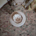 Load image into Gallery viewer, Vintage ceramic plate with intricate design on a floral-patterned rug
