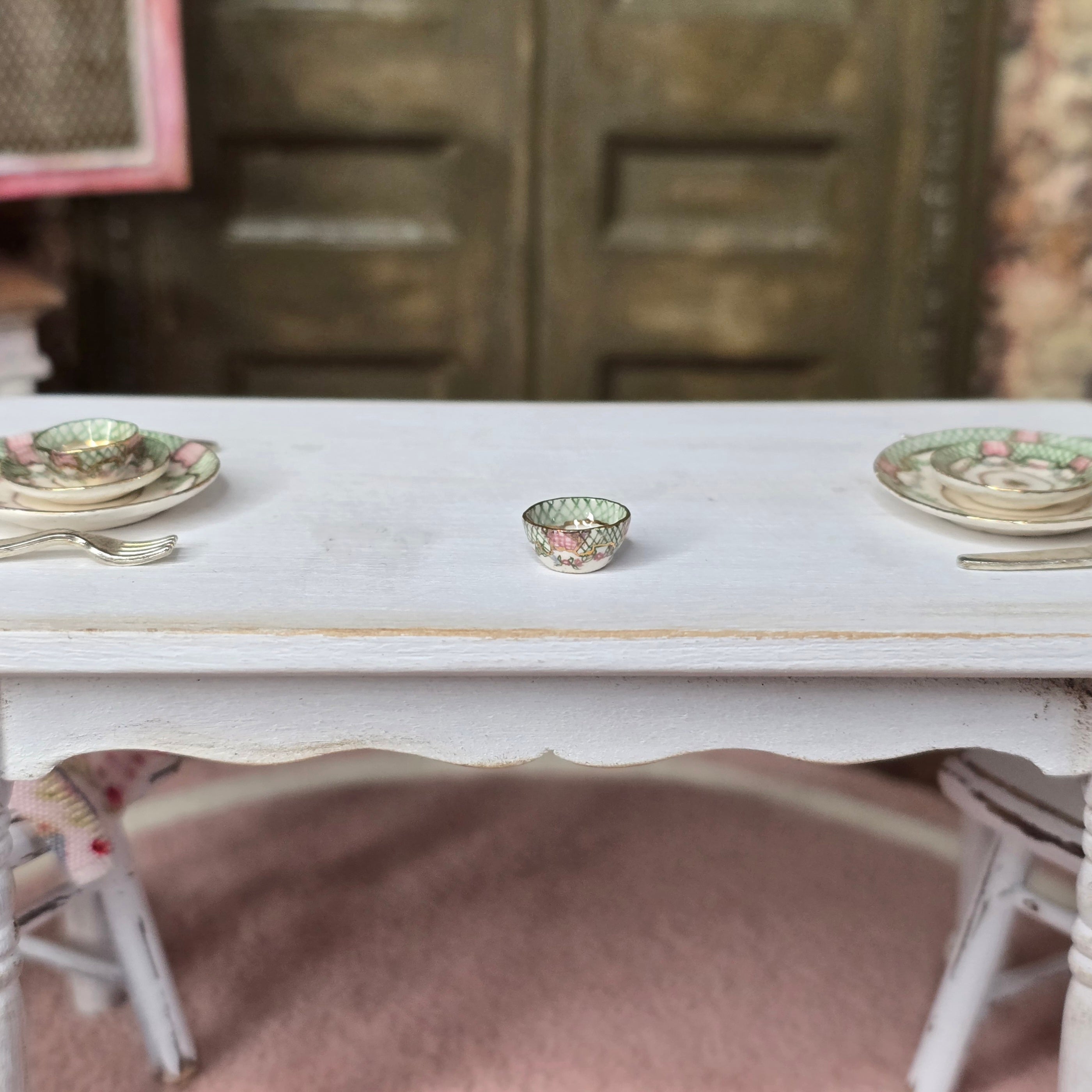 Painted porcelain miniature bowl on white table