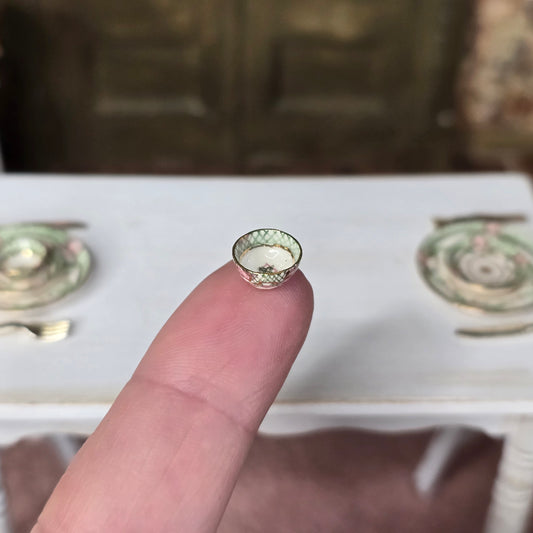 Small bowl balanced on finger for detail