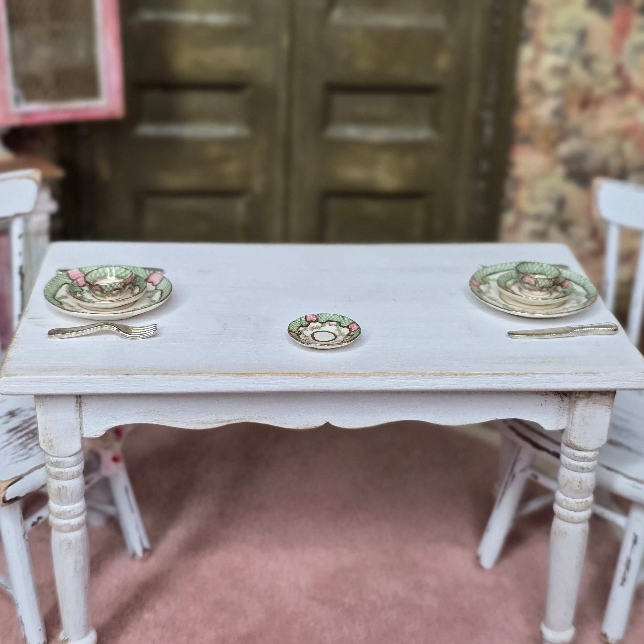 White table with miniature plates and chairs in a vintage setting