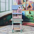 Load image into Gallery viewer, Laura Eppich 1:144 Lavender & Blue Three-Story Victorian Dollhouse on Blue Table
