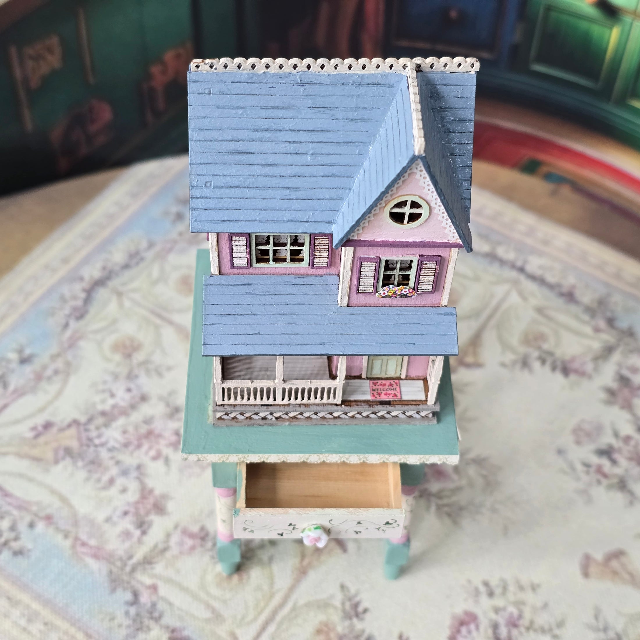 Laura Eppich 1:144 Lavender & Blue Three-Story Victorian Dollhouse on Blue Table