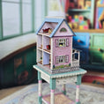 Load image into Gallery viewer, Laura Eppich 1:144 Lavender & Blue Three-Story Victorian Dollhouse on Blue Table
