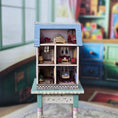 Load image into Gallery viewer, Laura Eppich 1:144 Lavender & Blue Three-Story Victorian Dollhouse on Blue Table
