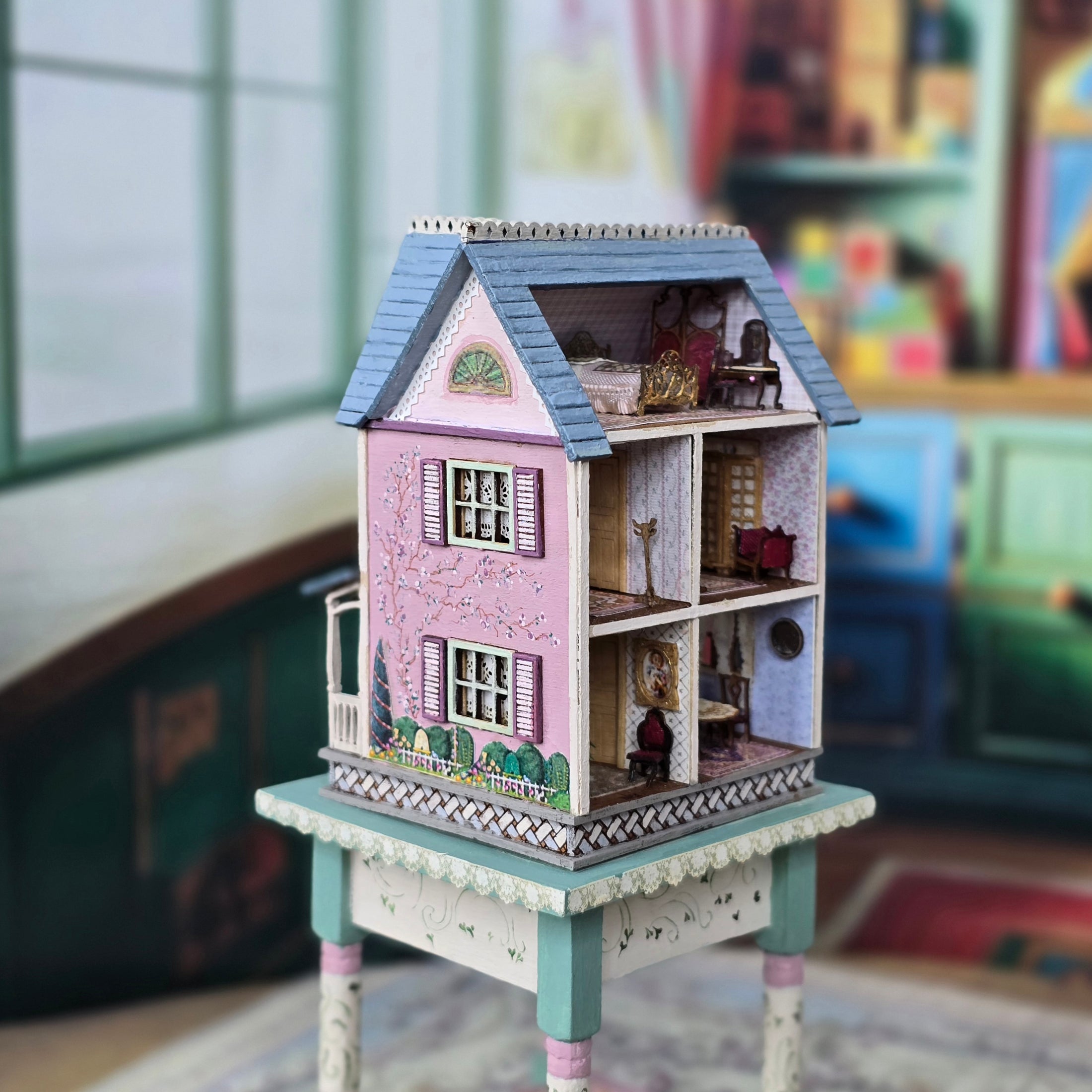 Laura Eppich 1:144 Lavender & Blue Three-Story Victorian Dollhouse on Blue Table