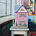 Load image into Gallery viewer, Laura Eppich 1:144 Lavender & Blue Three-Story Victorian Dollhouse on Blue Table
