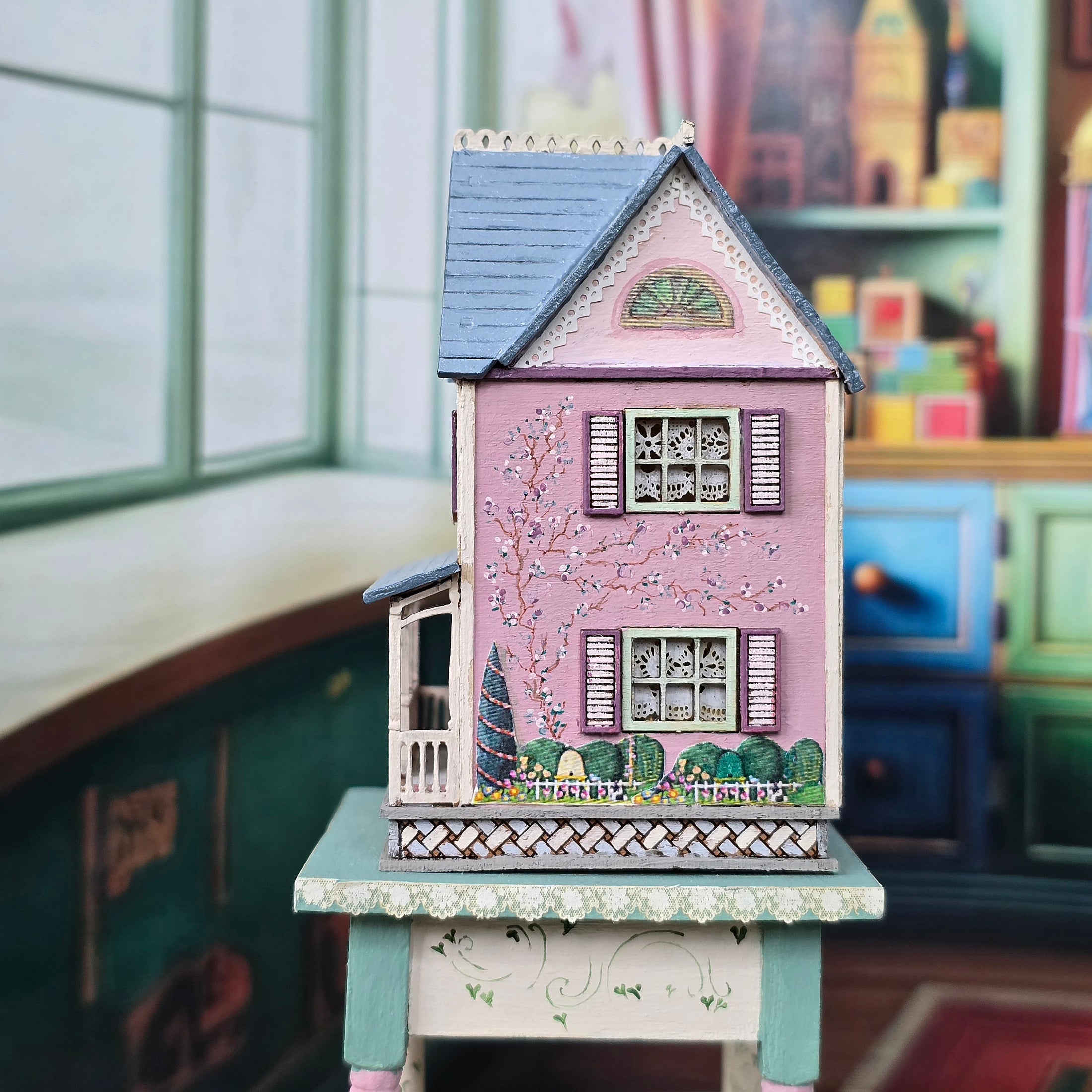 Laura Eppich 1:144 Lavender & Blue Three-Story Victorian Dollhouse on Blue Table