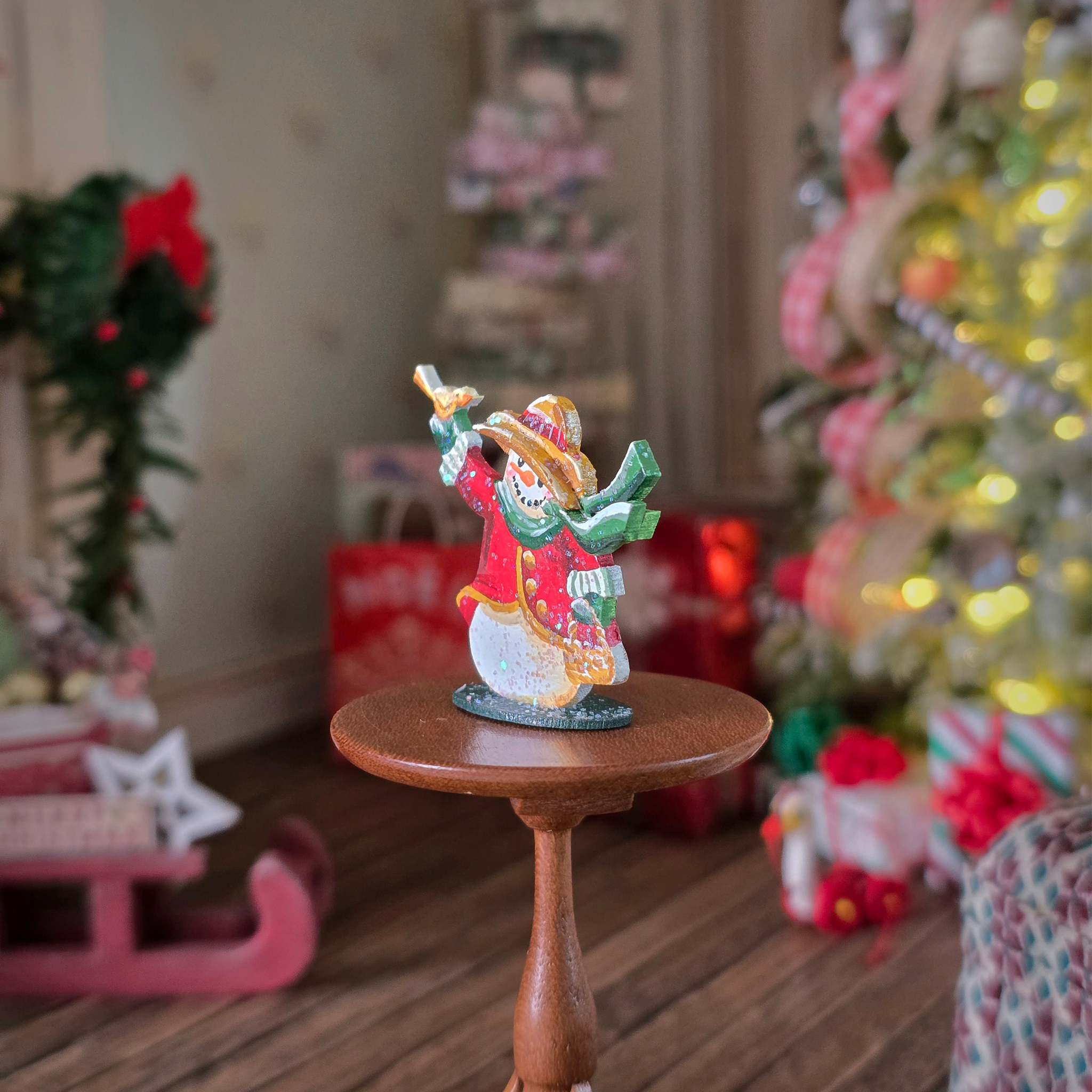 Decorative figurine on a small wooden stand with a festive background including a Christmas tree and presents.