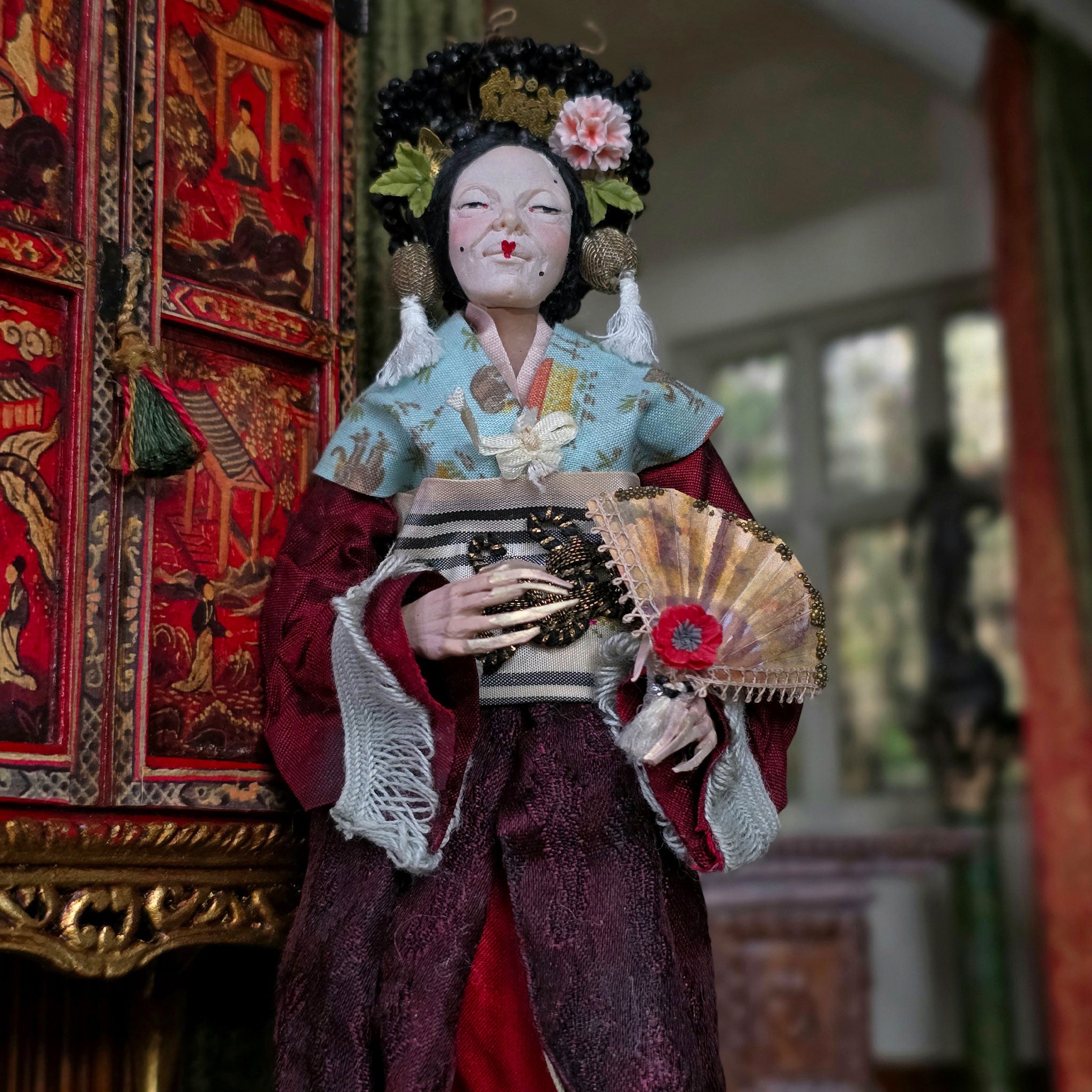 Traditional doll in intricate attire with a decorative background