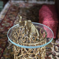 Load image into Gallery viewer, Gold elephant figurine on a decorative stand with a patterned rug in the background
