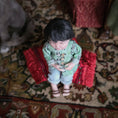 Load image into Gallery viewer, Miniature Chinese dollhouse character doll by Svetlana Blasing seated on a pillow.
