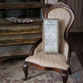 Load image into Gallery viewer, Vintage chair with a decorative gift box on a patterned rug

