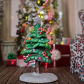 Load image into Gallery viewer, Decorative Christmas tree figurine with candy decorations on a wooden surface, with a blurred festive background.

