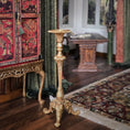Load image into Gallery viewer, Decorative gold pedestal candlestand in a room with ornate furniture and a patterned rug.
