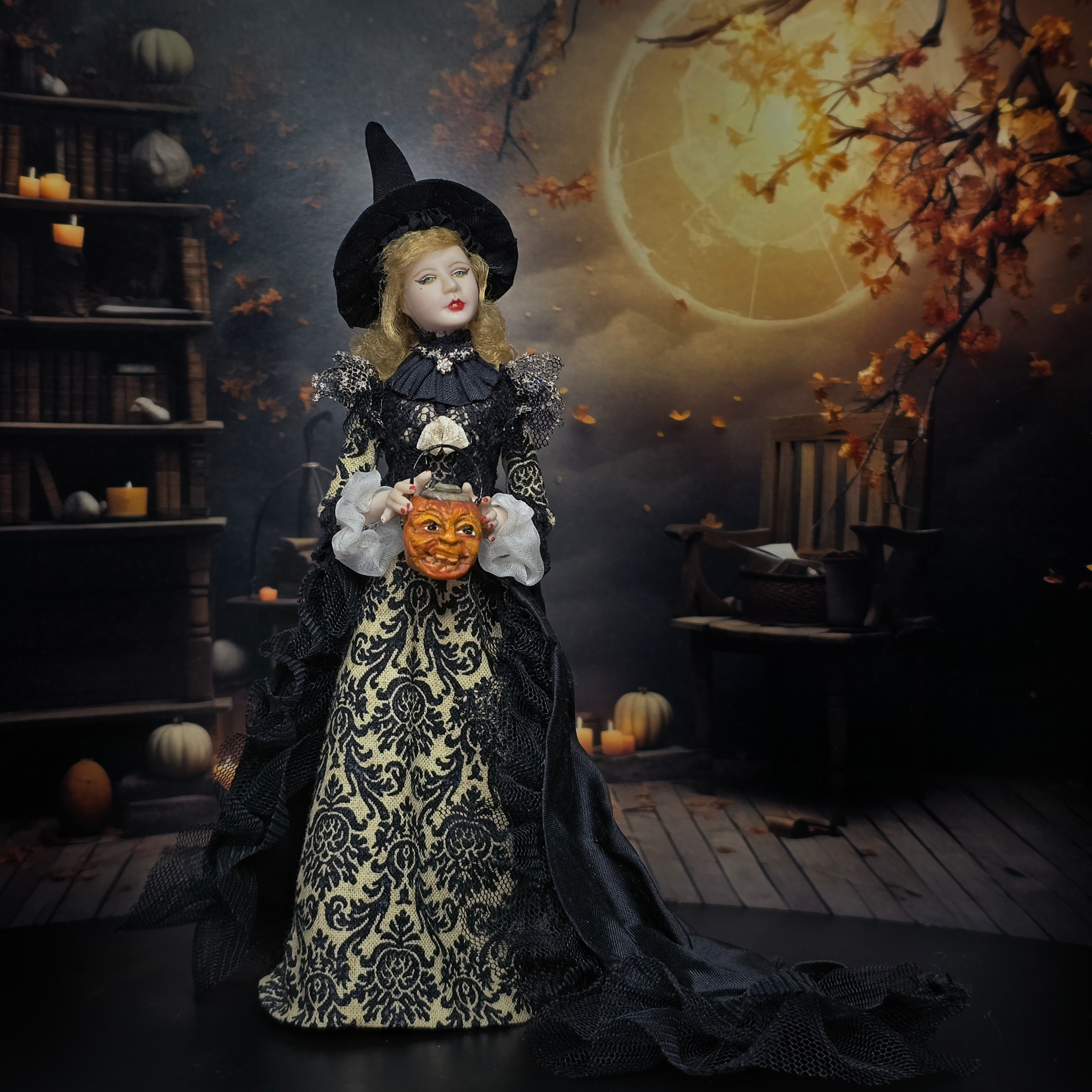 Halloween-themed dollhouse doll in a dark room with pumpkins and a full moon.