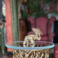 Load image into Gallery viewer, Gold elephant figurine on a round glass table with a blurred background
