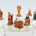 Load image into Gallery viewer, Set of nativity scene figurines on a clear stand with a white background
