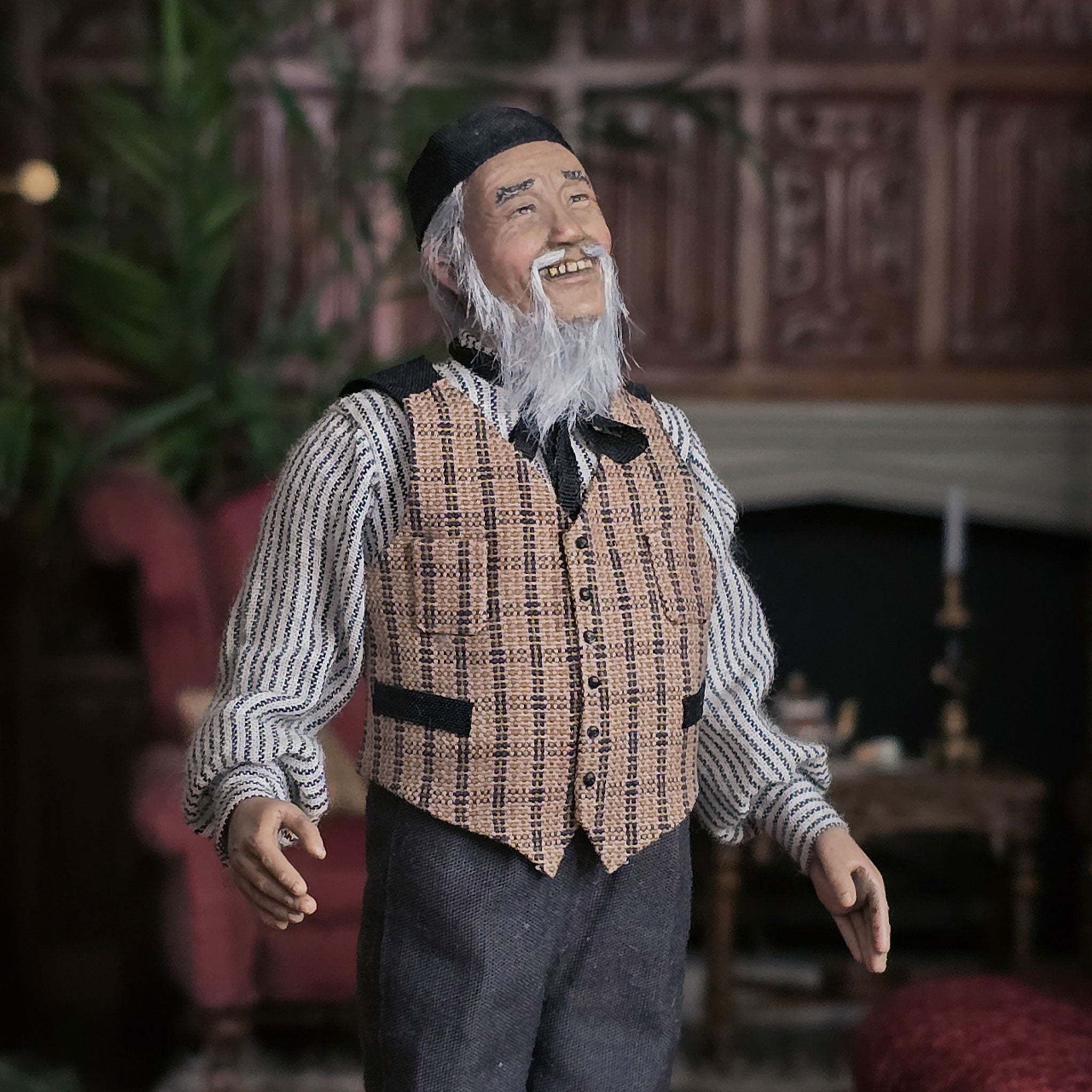 Vintage-style clay dollhouse doll of an elderly man with a long beard in a room setting.