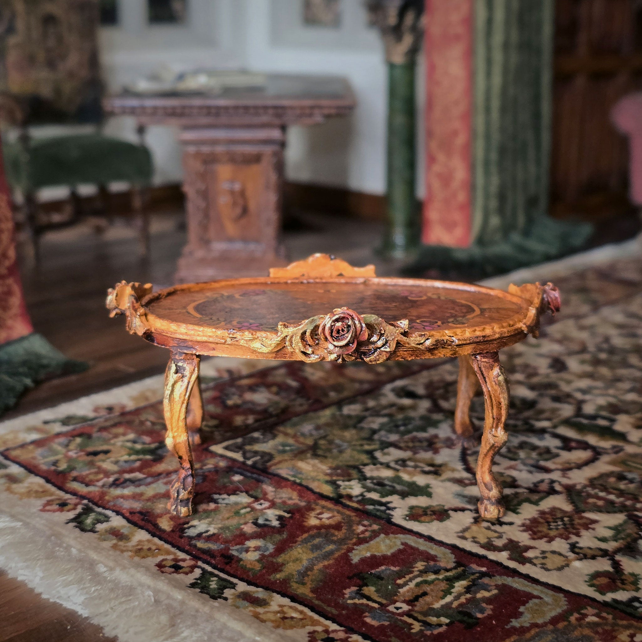Decorative wooden table with floral carvings on a patterned rug