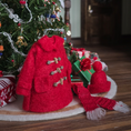 Load image into Gallery viewer, Knitted red coat with a matching hat and scarf in front of a decorated Christmas tree.
