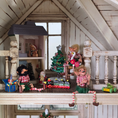 Load image into Gallery viewer, Decorative setup with elves and Christmas trees on a mantelpiece in a room with wooden walls.
