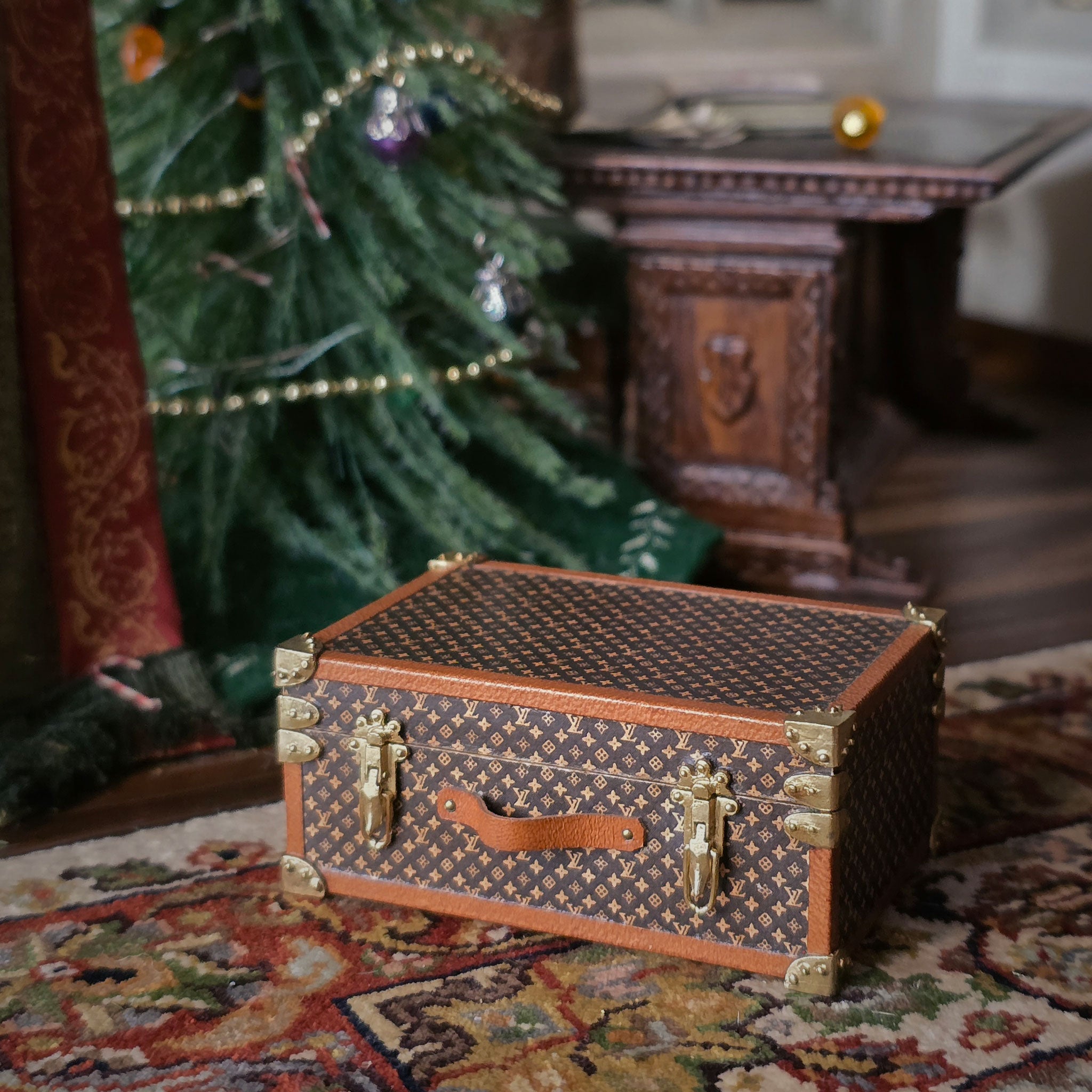 Decorative chest on a patterned rug with a Christmas tree in the background