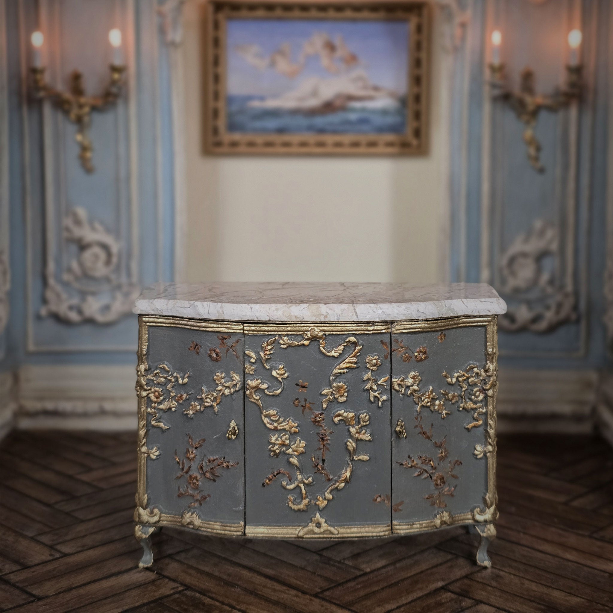 Decorative miniature sideboard cabinet with gold embellishments in a classical room setting. Cristina Noriega Moran