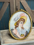 Load image into Gallery viewer, Antique Oval Framed Dollhouse Painted Portrait of Lady on Porcelain, on desk
