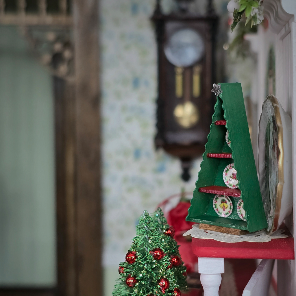 Signed Dollhouse Miniature Christmas Tree-Shaped Plate Display Box, side view in a festive room