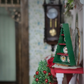 Load image into Gallery viewer, Signed Dollhouse Miniature Christmas Tree-Shaped Plate Display Box, side view in a festive room
