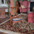 Load image into Gallery viewer, Wooden chair with a scenic needlepoint cushion on a patterned rug in a room with furniture and decor.

