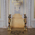 Load image into Gallery viewer, Decorative statues in a grand hallway with marble columns and high ceilings.
