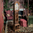Load image into Gallery viewer, Wooden grandfather clock in a miniature room setting with furniture and decor.
