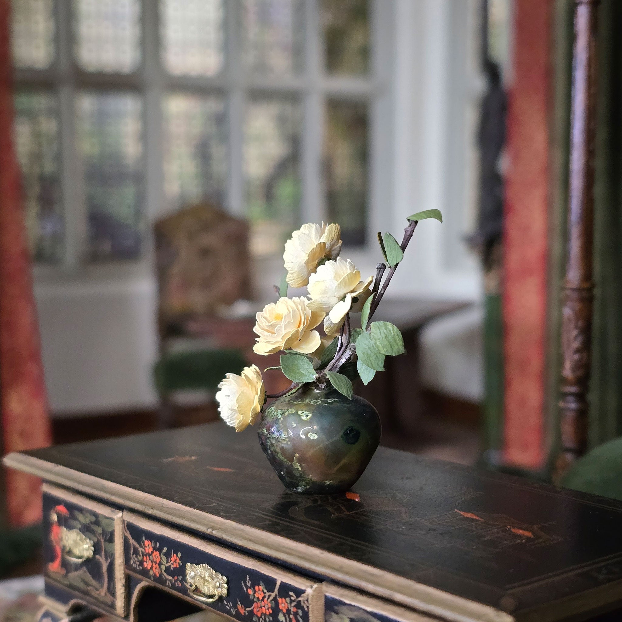 Vase with white flowers on a decorative table in a softly blurred room setting