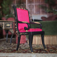 Load image into Gallery viewer, Chair with red cushion and black frame in a room setting
