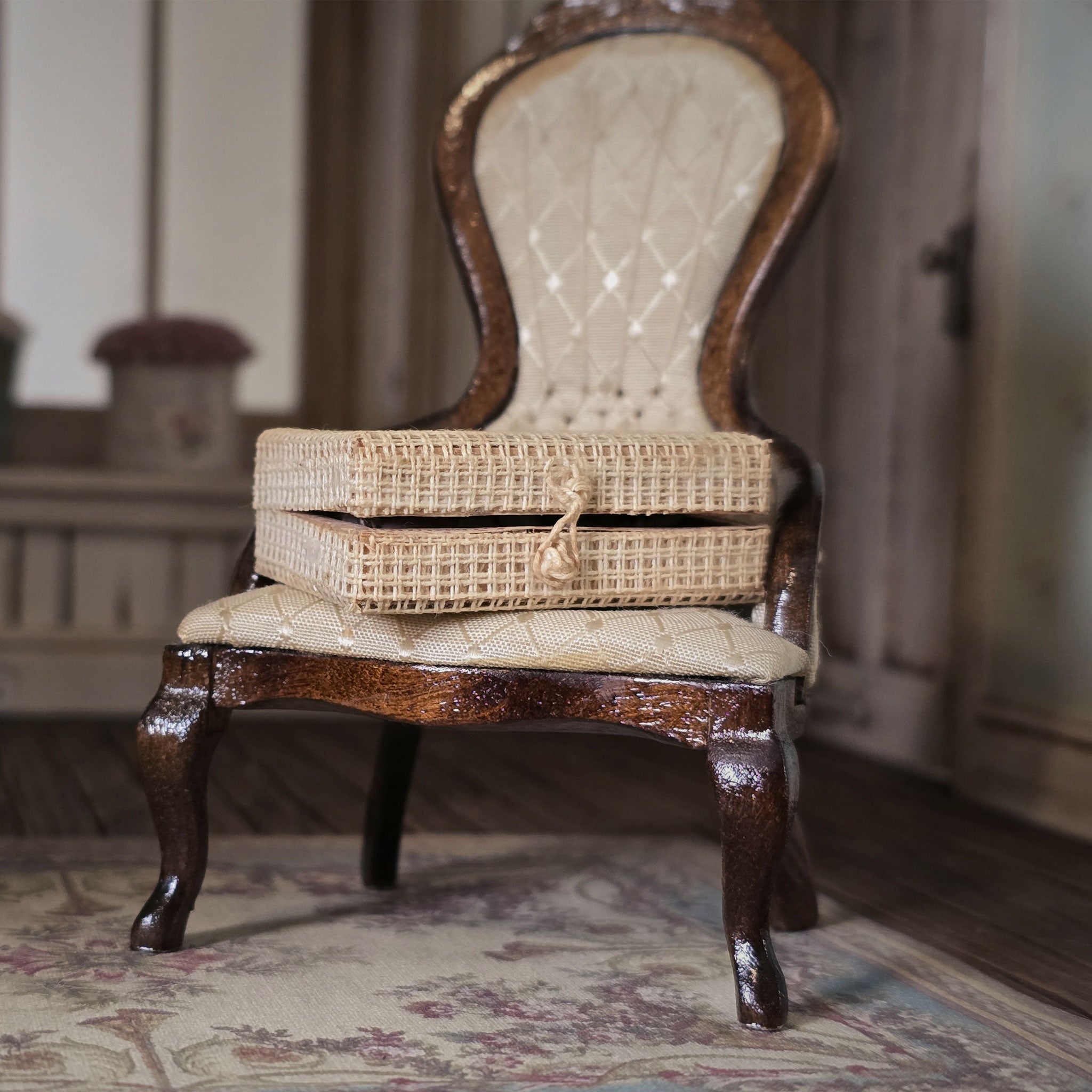 Wicker storage trunk on a wooden chair with a blurred background