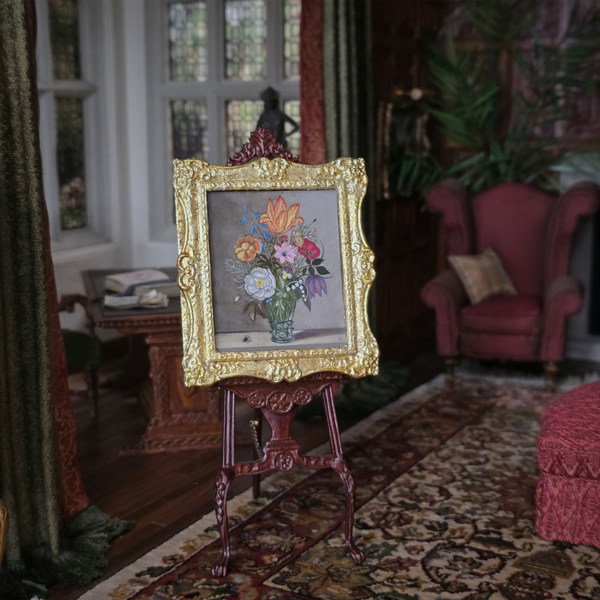 Decorative painting on a stand in an ornate room with furniture and plants.