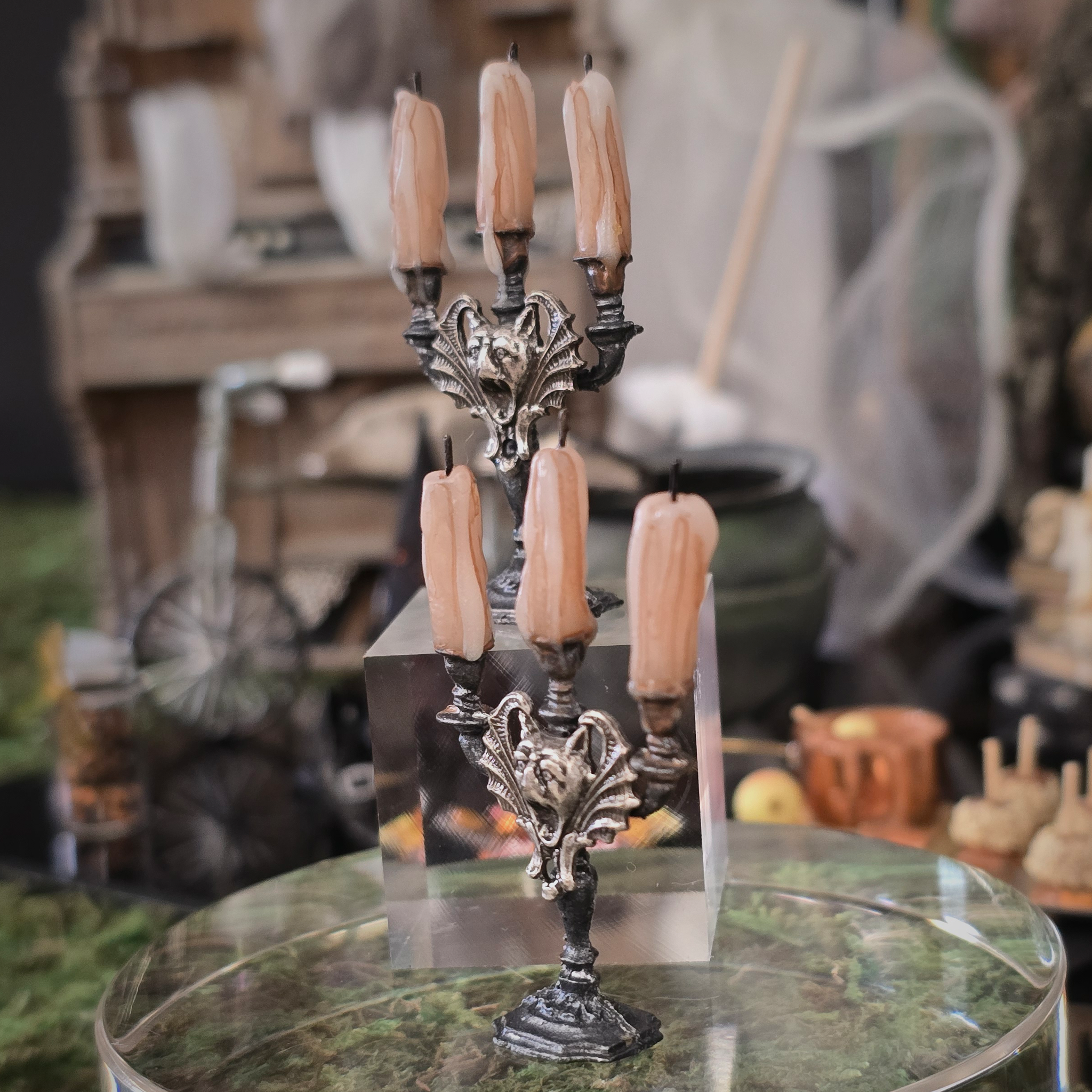Decorative candelabrum with candles on a table in a rustic setting