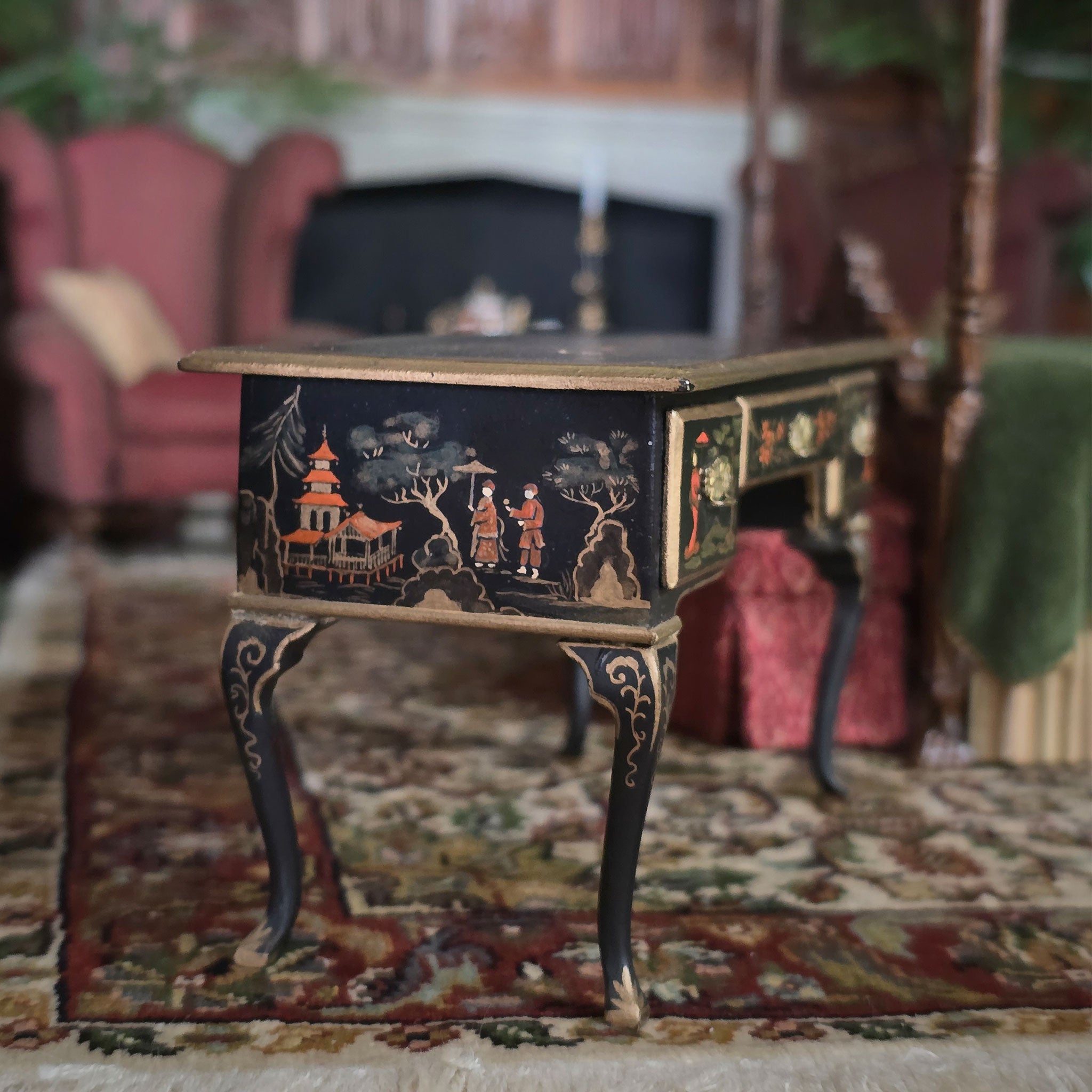 Decorative miniature desk with intricate designs on a patterned rug