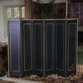 Load image into Gallery viewer, Black folding screen with gold trim in a room with stained glass windows and decorative rug.

