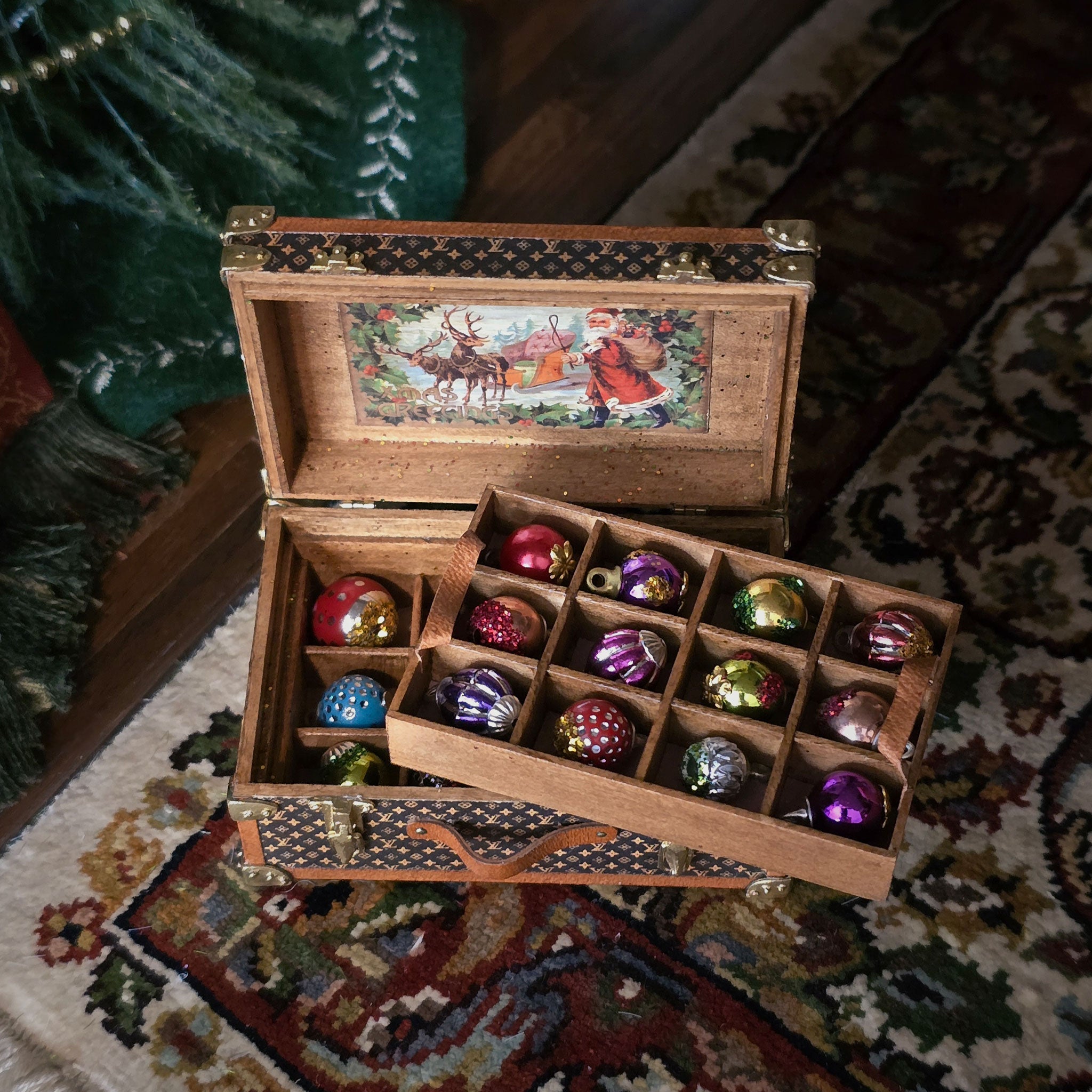 Wooden box with Christmas-themed ornaments on a patterned rug