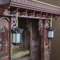 Load image into Gallery viewer, Decorative model of an architectural structure with intricate details and hanging lanterns.
