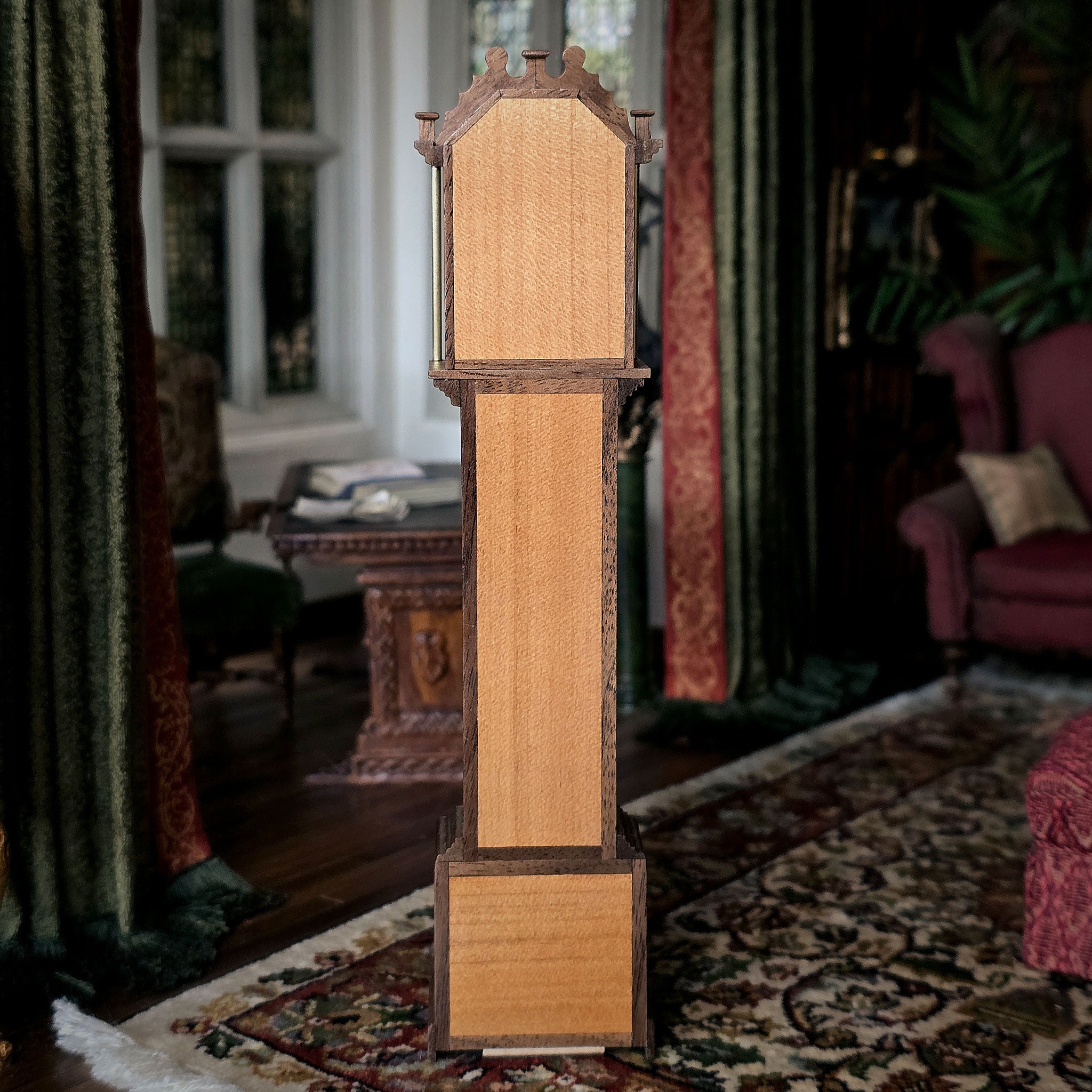 Wooden grandfather clock in a room with patterned rug and furniture