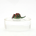 Load image into Gallery viewer, pair of Dollhouse miniature Decorative green and red elves shoes on a clear stand against a white background
