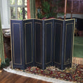 Load image into Gallery viewer, Black folding screen with gold trim in a room with decorative elements

