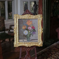 Load image into Gallery viewer, Decorative miniature painting still life of flowers in a gold frame on an easel in a room with classical decor.
