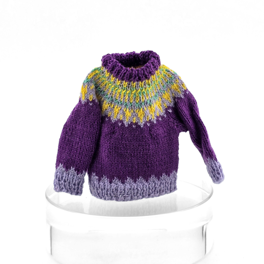 Dollhouse miniature hand Knitted purple sweater with a colorful pattern on a white background