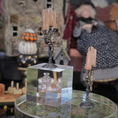 Load image into Gallery viewer, Decorative candlesticks on a clear stand with a blurred background
